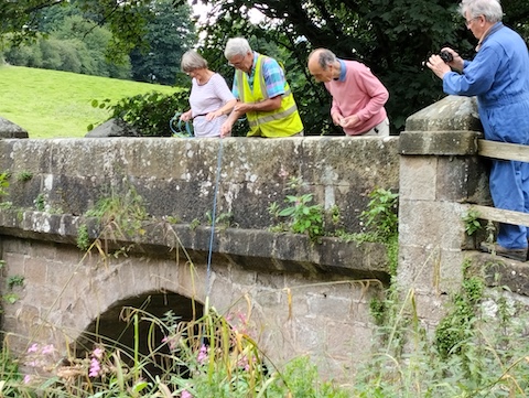 Oak Beck Spruisty bridge. Team 6’s volunteers from Bilton Conservation Trust carried out all the Oak Beck sampling. Keith photographs Shirley, Steve and John at this iconic location
